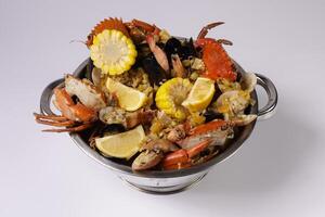 NORTH BEACH PREMIUM CLAWPINNO of fried fish, prawn, corn, shellfish and crab top view on grey background singapore food photo