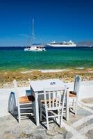 Catamaran yacht and cruise liner is Aegean sea. Chora, Mykonos island, Greece photo