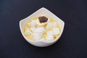 lontong sayur- Compressed rice cake served with curry coconut milk sauce and vegetables and boiled egg photo