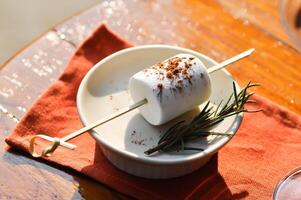 marshmallow with chocolate powder topping or marshmallow for fondue photo