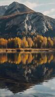 AI generated In autumn, A serene lake reflects the majestic mountain and surrounding forest of yellow-leaved trees. ai generative photo