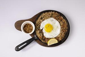 SPAMBALAYA fried rice with sunny egg in a dish top view on grey background singapore food photo