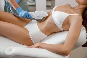 Slim young woman getting photo epilation with ipl machine in beauty salon