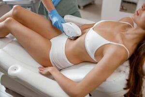 Woman with smooth skin getting photo epilation with ipl machine in beauty salon