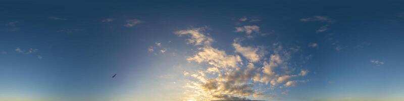 Dark blue sunset sky panorama with Cumulus clouds. Seamless hdr pano in spherical equirectangular format. Complete zenith for 3D visualization, game and sky replacement for aerial drone 360 panoramas. photo