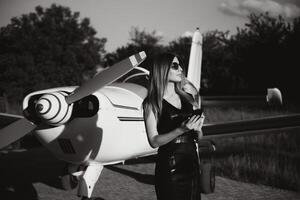 beautiful young business woman near the airplane jet at sunny day in airport photo