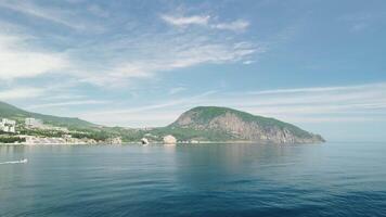 Gurzuf resort city panoramic view on Bear Mountain, Ayu-Dag, Yalta, Crimea. Spring sunny day. Nature summer ocean sea beach background. Vacation, travel and holiday concept. video