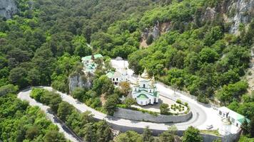 Christian church in the mountains above the sea. Temple of the Holy Archangel Michael in Oreanda. The southern coast of Crimea. Aerial view video