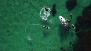 A man flies on a FlyBoard. Aerial top down view. Water extreme sport, azure summer sea with outdoors active people enjoying water sports. Flyboarding and seariding, Recreation and sports concepts. video