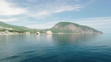 Gurzuf resort city panoramic view on Bear Mountain, Ayu-Dag, Yalta, Crimea. Spring sunny day. Nature summer ocean sea beach background. Vacation, travel and holiday concept. video