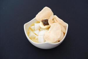 lontong sayur- Compressed rice cake served with curry coconut milk sauce and vegetables and boiled egg photo