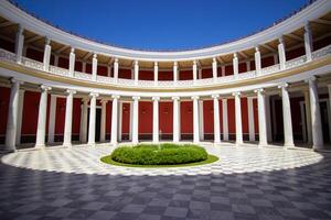 1 September 2023, Athens, Greece. The beautiful view of the Zappeion mansion inner yard. The harmony of red, green, and white. Famous place for official and private meetings and ceremonies. photo