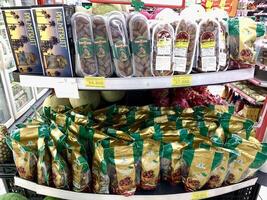 Indonesia - Sibolga, 10 Maret 2024 Various kinds of fruit such as dates, watermelon and pears are arranged on supermarket shelves for consumers to buy photo