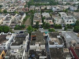 Rectangular shaped settlement of the rich district, looking down aerial view from above Bird eye view villas with pool on 2023-07-22 in Lahore Pakistan photo