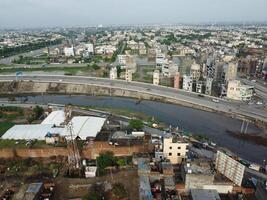 View at city from bird sight. City from drone. Aerial photo. City scape from drone on 2023-07-22 in Lahore Pakistan photo