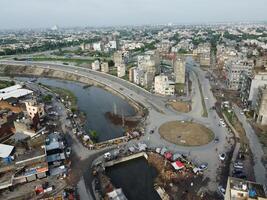 View at city from bird sight. City from drone. Aerial photo. City scape from drone on 2023-07-22 in Lahore Pakistan photo