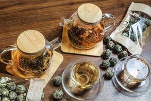 Wooden Table With Green Tea-filled Teapot photo