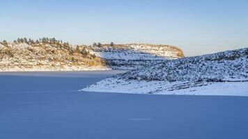 winter sunset over frozen Horsetooth Reservoir and Satanka Cove at foothills of northern Colorado photo