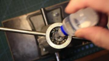 a mechanic cuts a thread by hand using a die, top view video