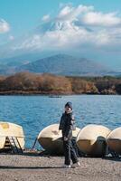 Woman tourist enjoy with Fuji Mountain at Lake Shoji, happy Traveler sightseeing Mount Fuji and road trip Fuji Five Lakes. Landmark for tourists attraction. Japan Travel, Destination and Vacation photo