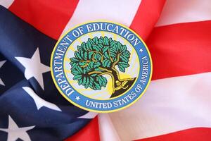 KYIV, UKRAINE - MARCH 9, 2024 US Department of Education seal on United States of America flag photo