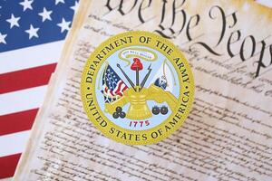 KYIV, UKRAINE - MARCH 9, 2024 US Department of Army seal with United States Constitution on flag photo