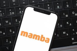 KYIV, UKRAINE - FEBRUARY 23, 2024 Mamba logo of famous dating website or app on iPhone display photo