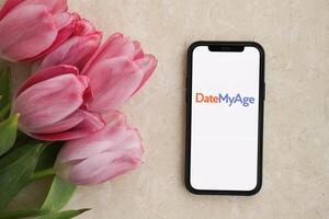 KYIV, UKRAINE - FEBRUARY 23, 2024 DateMyAge logo of famous dating website or app on iPhone display photo