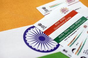 Indian Aadhaar card from Unique Identification Authority of India on Indian flag photo