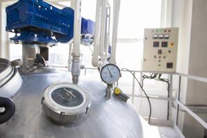 Belarus, the city of Mensk, April 12, 2019. Chemical production.Metal industrial tank with valve and gauge. Fragment from chemical production photo