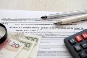 Information about deductions from income and tax, PIT-O form on accountant table with pen and polish zloty money bills photo