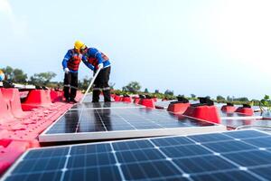 Photovoltaic engineers work on floating photovoltaics. workers Inspect and repair the solar panel equipment floating on water. Engineer working setup Floating solar panels Platform system on the lake. photo