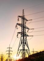 Silhouette of electricity consctructions. Electric tower distribution. photo