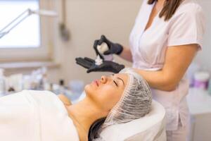 A cosmetologist-esthetician treats problem skin photo