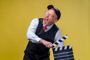 Film directing. Film production. Human emotions. Man with movie flap while filming. Close up. photo