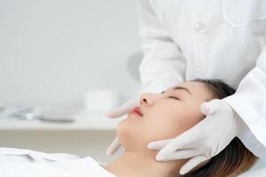 plastic surgery, beauty, Surgeon or beautician touching woman face, surgical procedure that involve altering shape of face, doctor examines patient facey, medical assistance, health photo