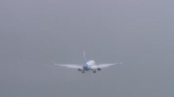 PHUKET, THAILAND - JANUUARY 25, 2023. Boeing 737-9 MAX , UP-B3727 of SCAT Airlines approach to land and go around, rear view. Rain, strong cross wind. video