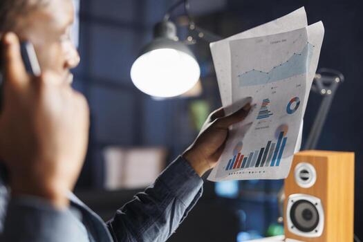 Economic counselor contacts auditor to discuss legal cash processing, financial resources, and cost variables. On phone, african american man addresses capital funds irregularity. photo