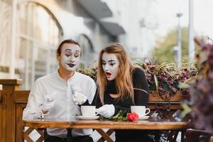 A couple of merry mimes. He hurries on a date. photo