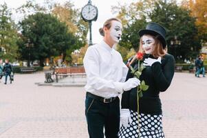 A couple of merry mimes. He hurries on a date. photo