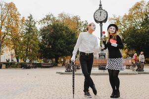 A couple of merry mimes. He hurries on a date. photo