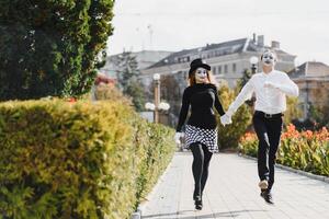 A couple of merry mimes. He hurries on a date. photo