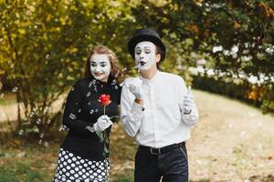 A couple of merry mimes. He hurries on a date. photo