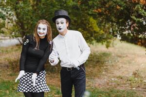 A couple of merry mimes. He hurries on a date. photo
