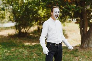 Portrait of a man, artist,clown, MIME. Shows something. Mime actor shows different emotions. photo