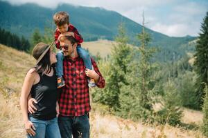 Family stay on the top of mountain, looking on the beautiful view photo