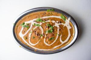 Spicy Dal Makhani or butter daal served in a dish isolated on grey background top view of bangladesh food photo