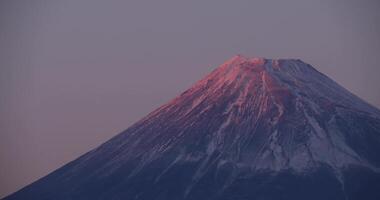 A dusk of Mt.Fuji behind the blue sky in winter telephoto shot video