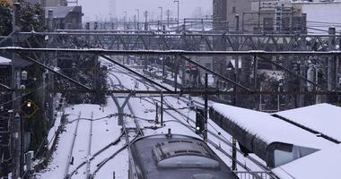 Falling snow at the station in Tokyo handheld shot video