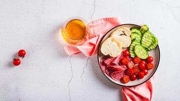 Girl dinner of smoked meats, vegetables and bread on a plate on the table top view web banner photo